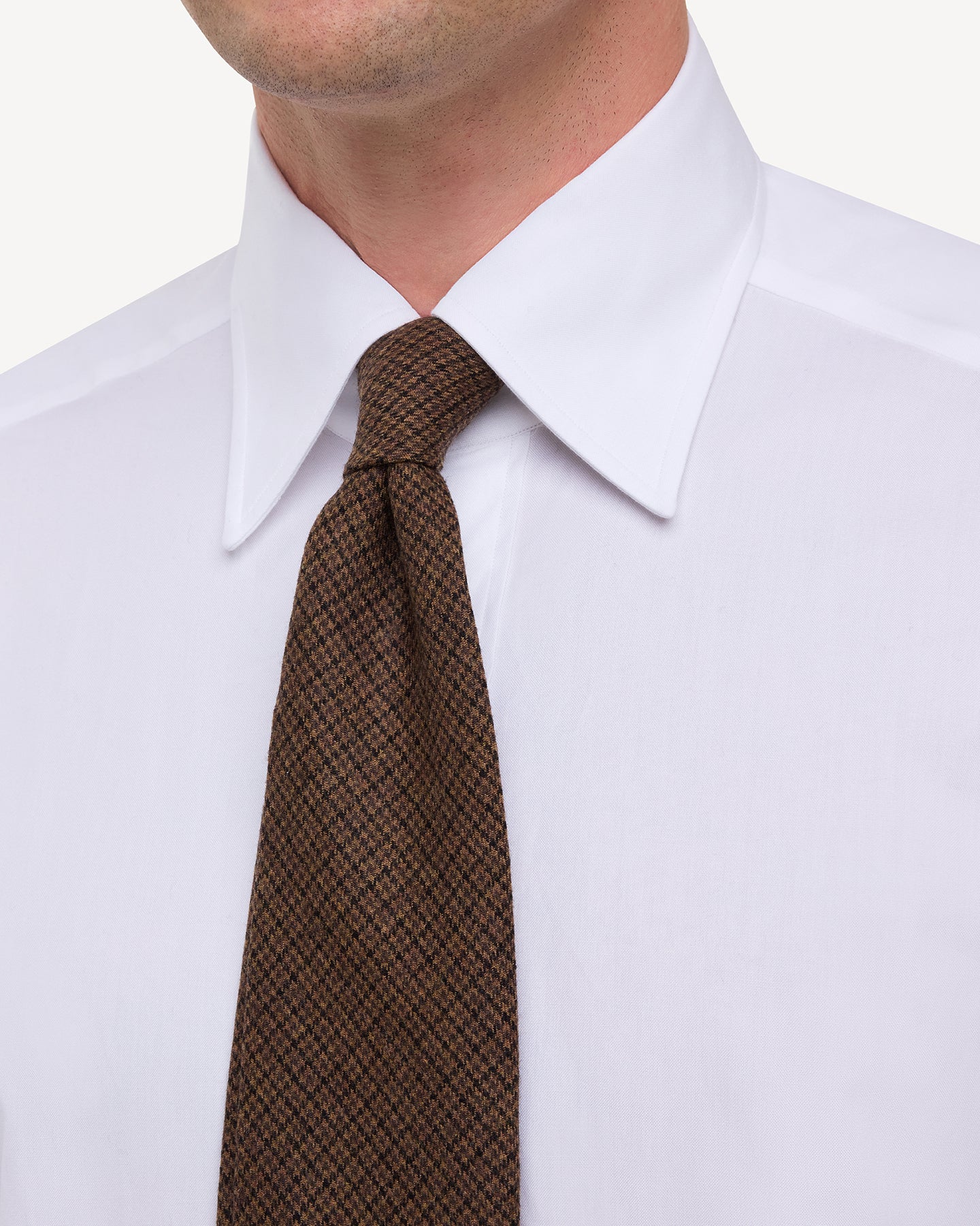 Man wearing white point collar shirt with Brown Fox Brothers Worsted Flannel Gun Club Tie