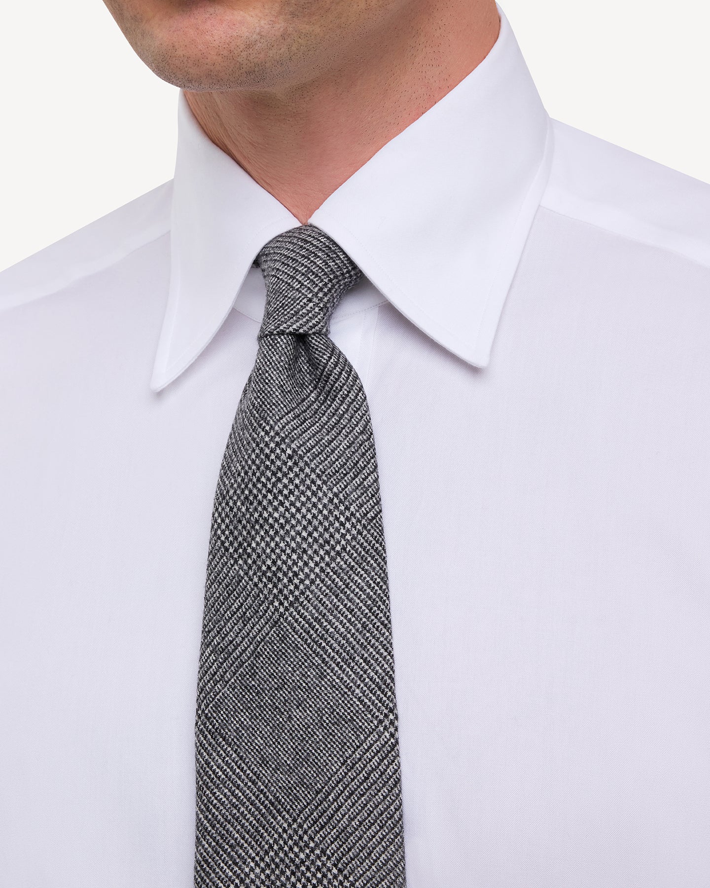 Man wearing white point collar shirt with Grey Fox Brothers Worsted Flannel Prince of Wales Tie