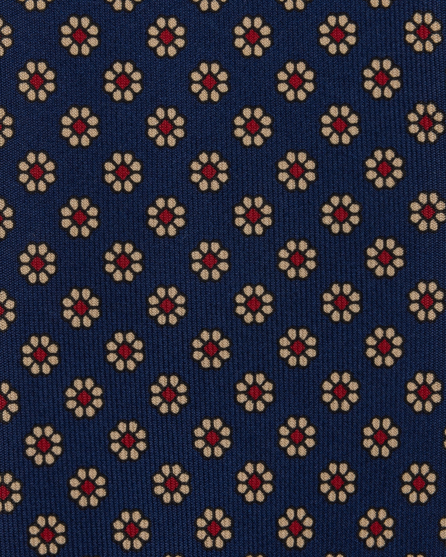 Navy Ancient Madder tie with floral pattern in shades of cream and red.