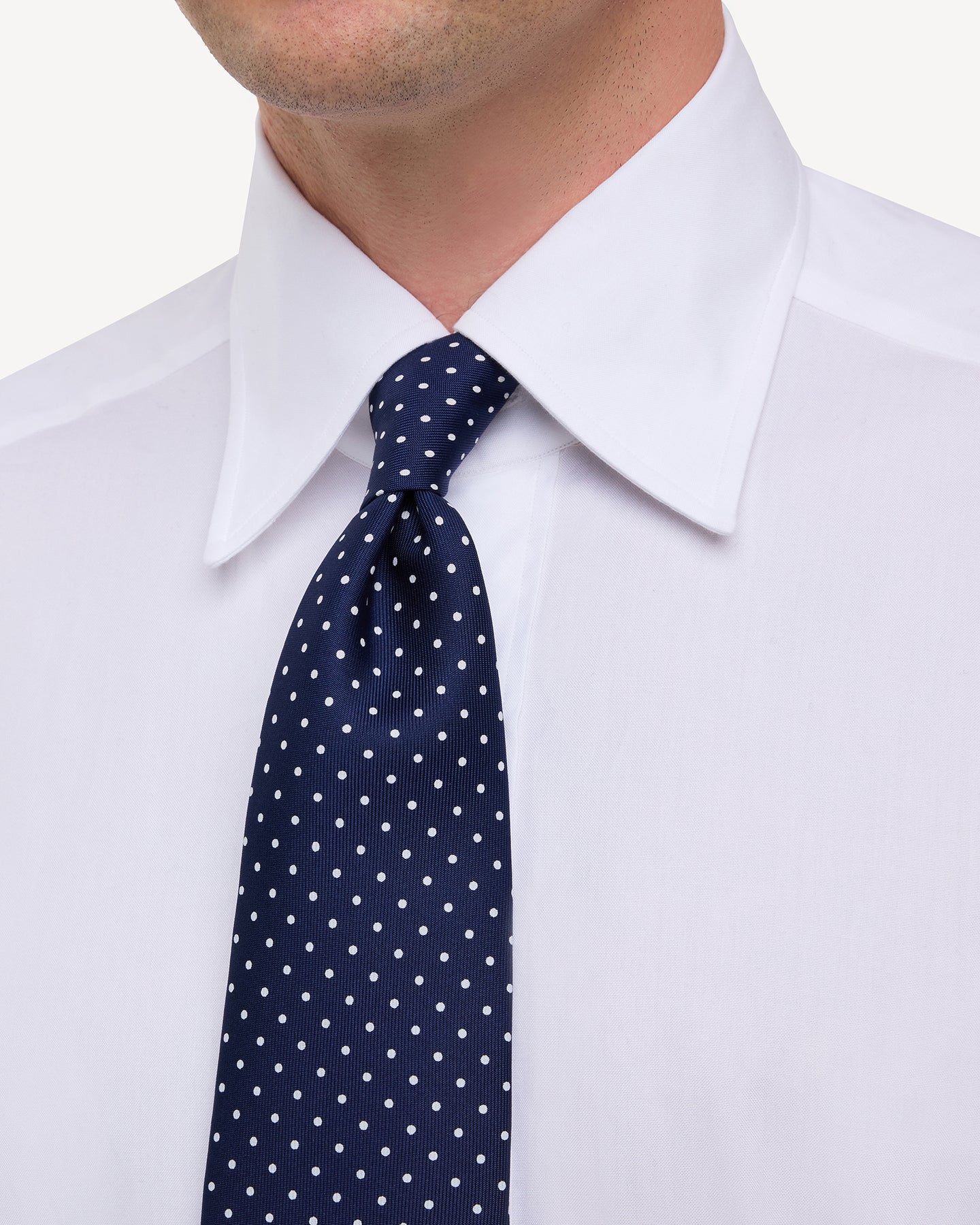 Man wearing white point collar shirt shirt and Navy White Polka dot Printed Silk Tie