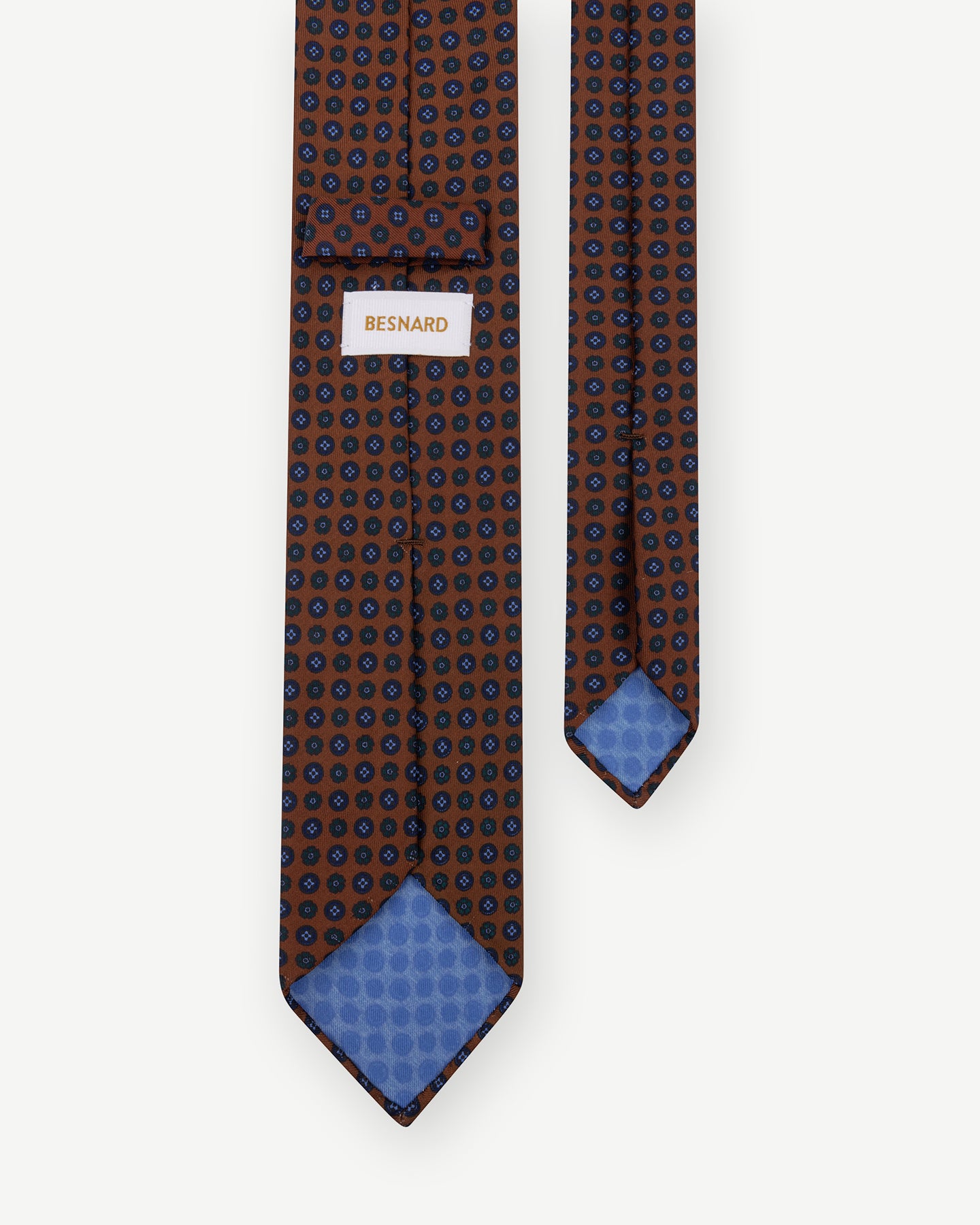 Rust Ancient Madder tie with small floral pattern and handrolled blades