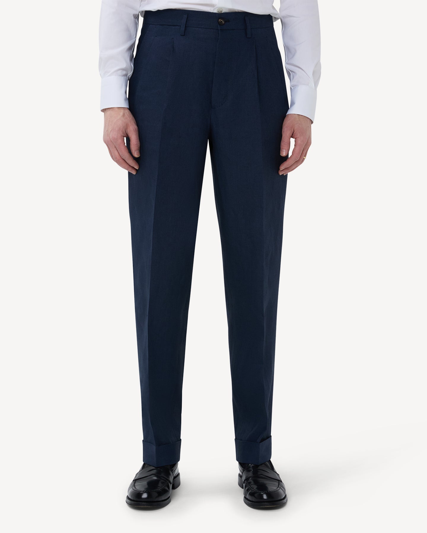 The front of navy linen trousers with double pleats and belt loops