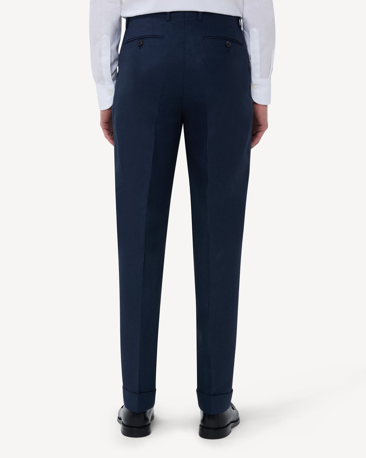 The back of navy linen trousers with double pleats and belt loops