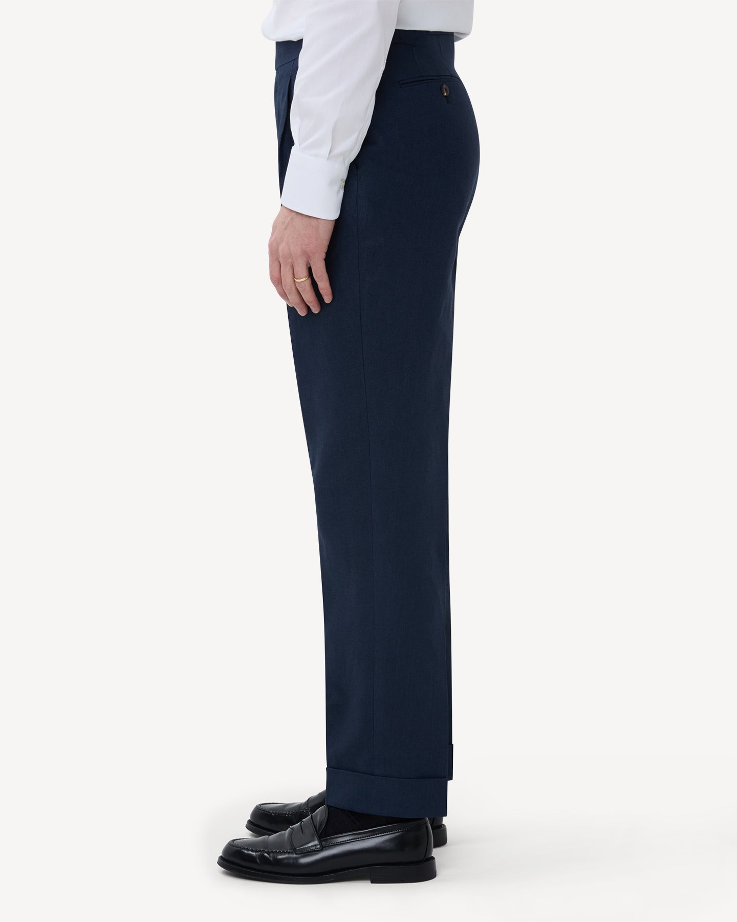 The side of navy linen trousers with single pleats and side adjusters
