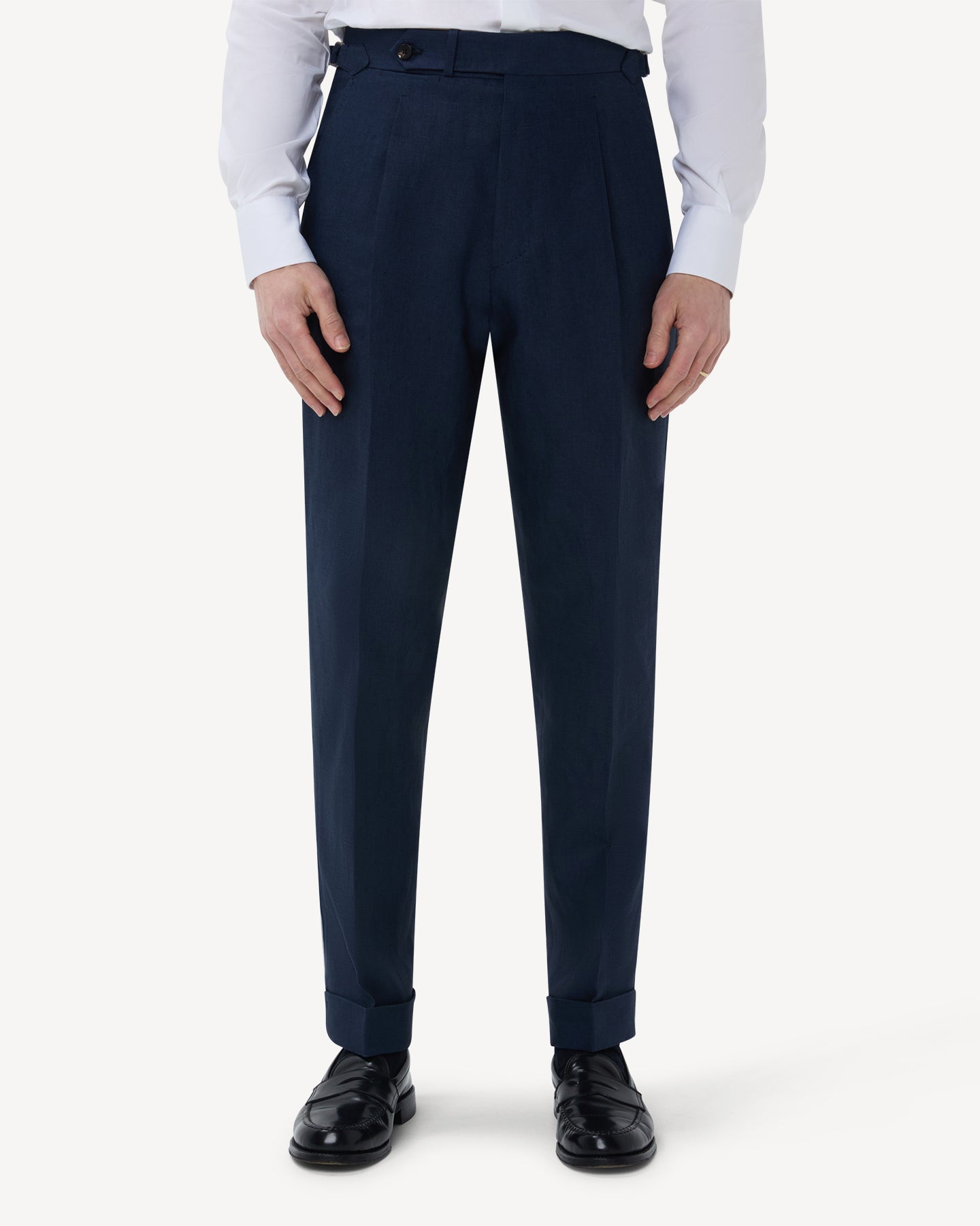 The front of navy linen trousers with single pleats and side adjusters