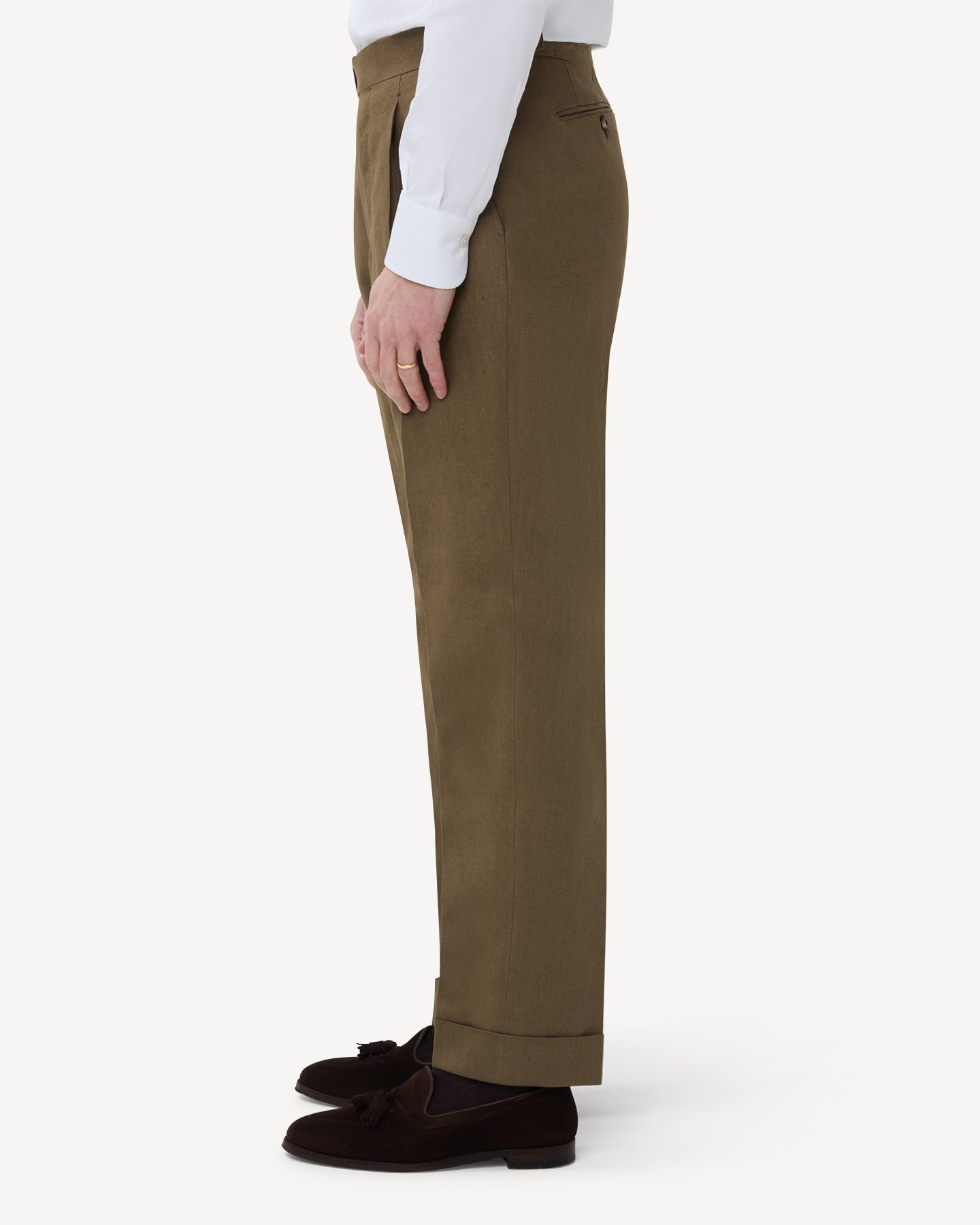 The side of olive brown linen trousers with single pleats and side adjusters