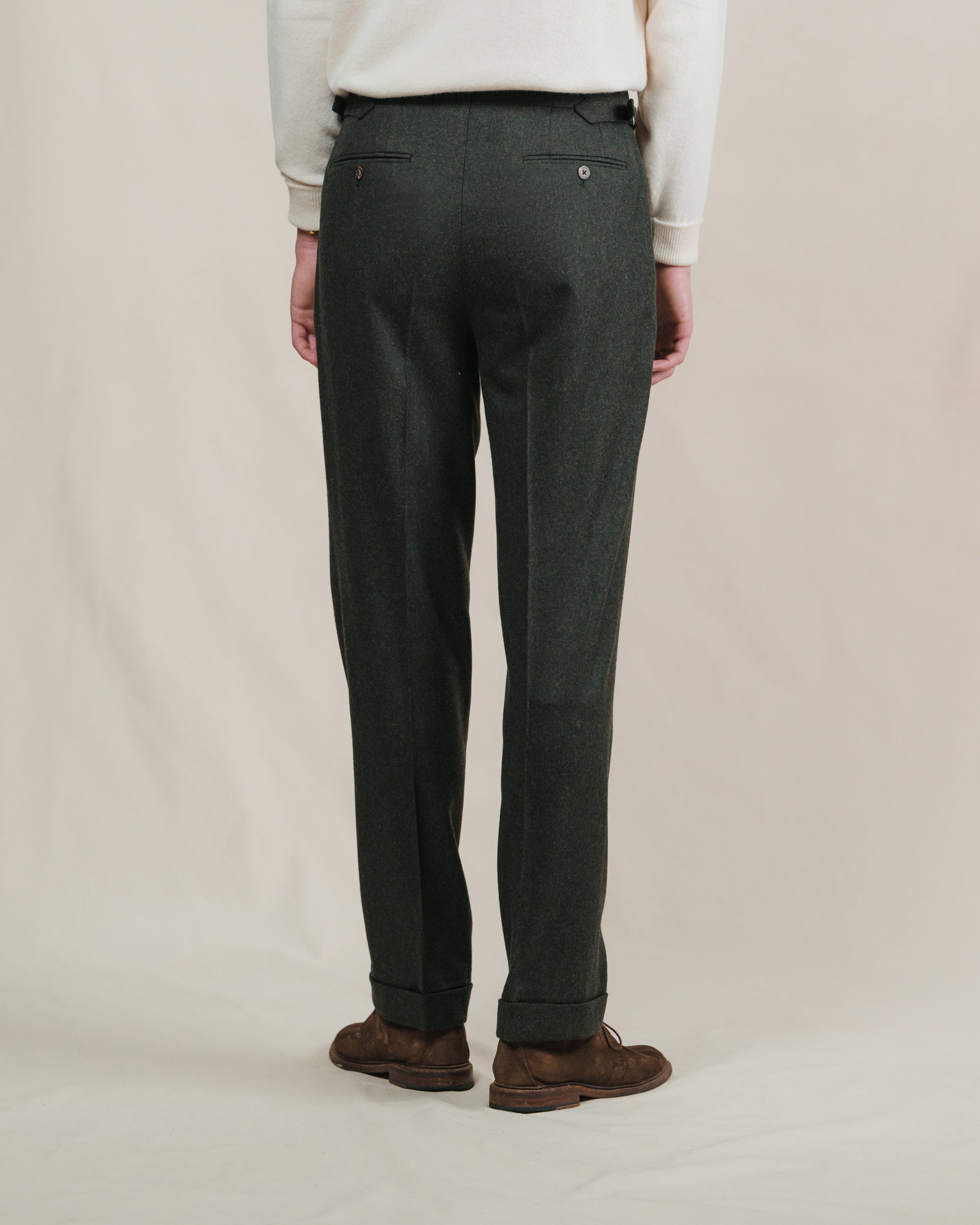 Man wearing dark green flannel trousers with brown suede chukkah boots