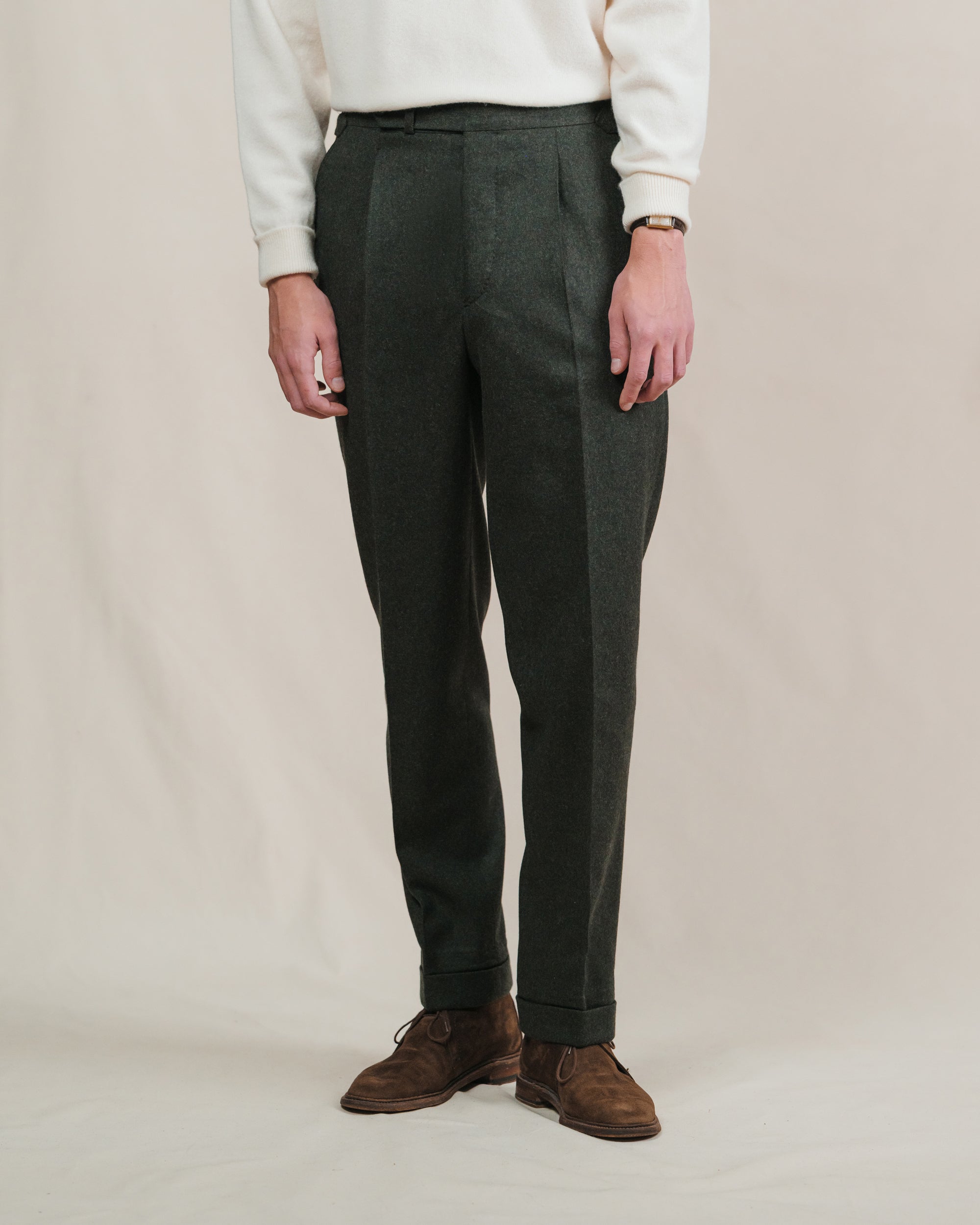 Man wearing dark green flannel trousers with brown suede chukkah boots