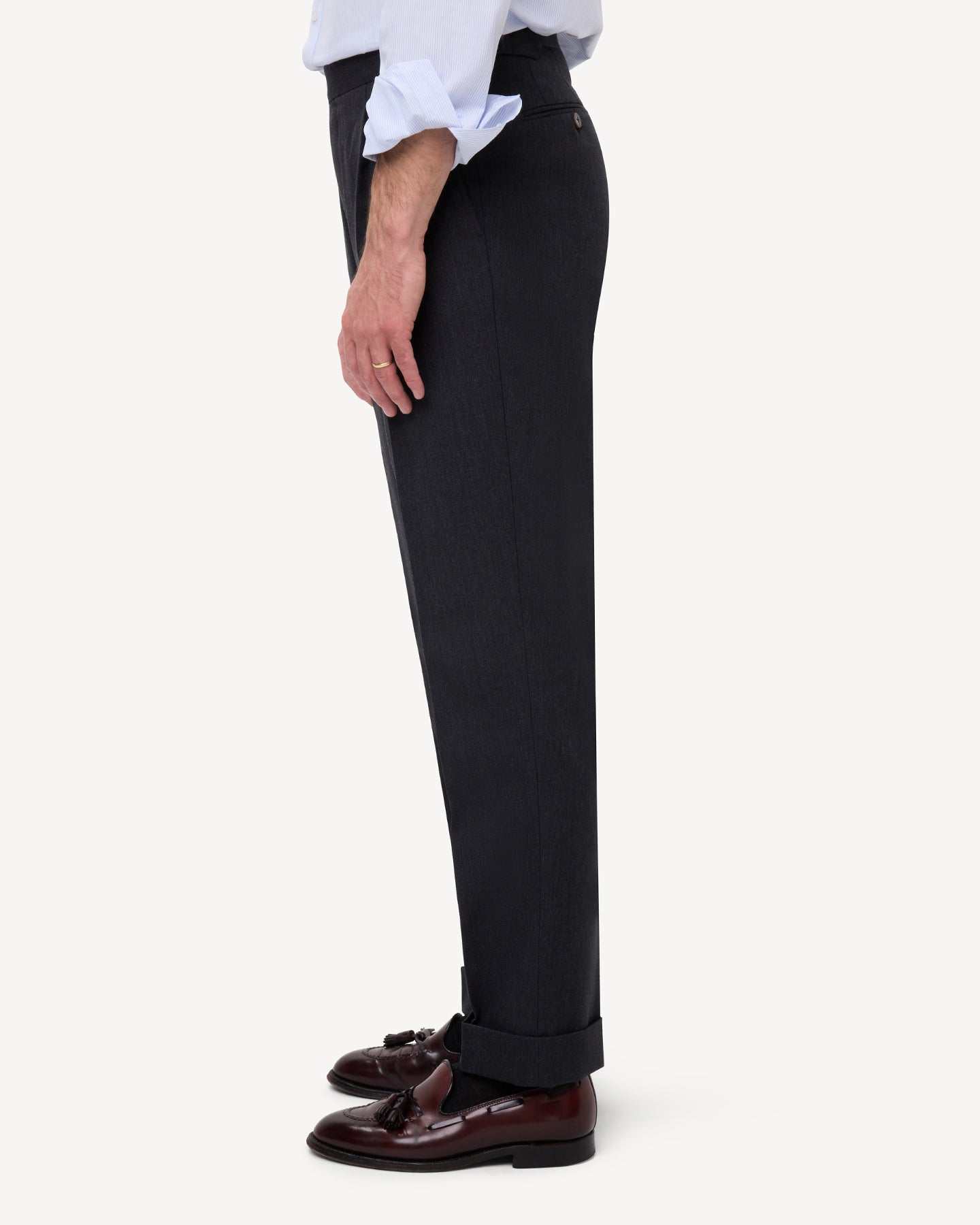 Side view of dark grey cavalry twill trousers with single pleats and side adjusters