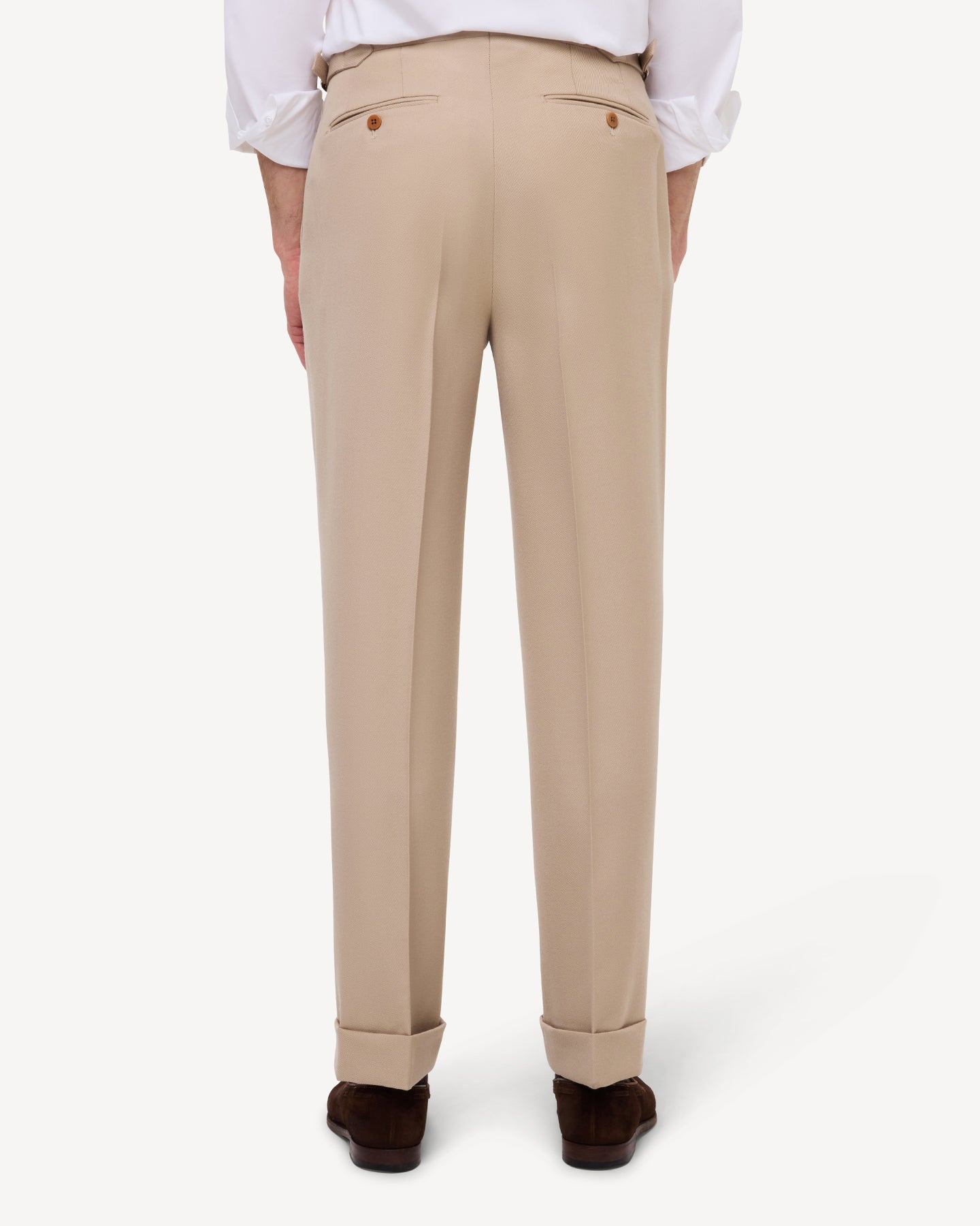 Back view of light tan cavalry twill trousers with single pleats and side adjusters